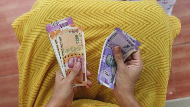 Counting Indian currency Rupee , hand giving Indian money 100, 200, 2000 rupees banknote Kerala India 4K slow motion video, footage. Business woman counting giving money cash new Indian currency notes