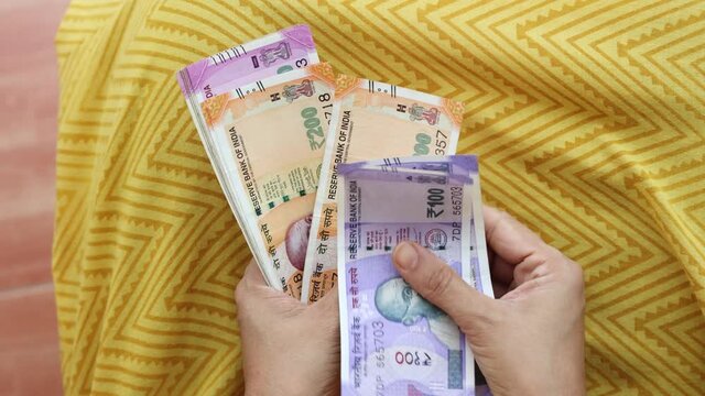 Counting Indian currency Rupee , hand giving Indian money 100, 200, 2000 rupees banknote Kerala India 4K slow motion video, footage. Business woman counting giving money cash new Indian currency notes