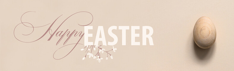 One Easter egg on a neutral pastel background. Minimalistic flat lay composition. Greeting card with text Happy Easter. Modern Trendy Easter Top View Composition. Banner format 