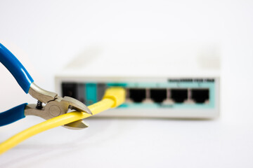 Network cable is plugged into router. Yellow cable in Wi-Fi router. White router with power cord. Router rear view with connections.