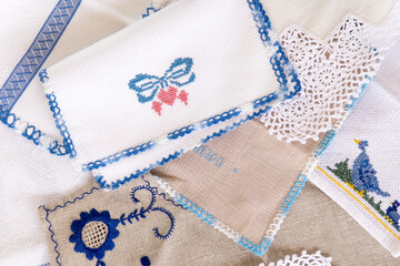 Close up of stitch cloth heart shape and bow on white fabric, napkin. Handmade favorite hobby or handcraft, baby patchwork