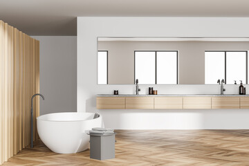 Wooden bathroom interior with bathtub and sinks with parquet floor