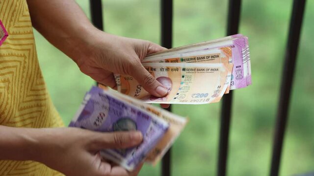 Counting Indian currency Rupee , hand giving Indian money 100, 200, 2000 rupees banknote Kerala India 4K slow motion video, footage. Business woman counting giving money cash new Indian currency notes