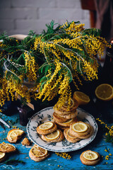 biscuits with lemon with a bouquet of mimosa.style vintage