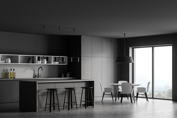 Grey kitchen interior with table and chairs near window, concrete floor