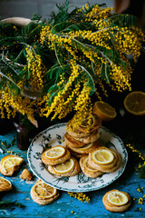 biscuits with lemon with a bouquet of mimosa.style vintage