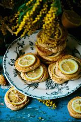 Fototapeta na wymiar biscuits with lemon with a bouquet of mimosa.style vintage