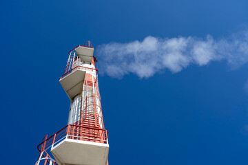 Close Up Shot of Smoke Coming Out from Power Plant Chimney Against The Blue Sky
