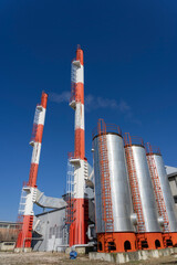 District Heating Plant Exterior With Industrial Chimneys Against the Blue Sky