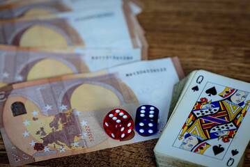 several colored dice and euro money