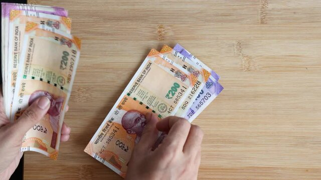 Counting Indian currency Rupee , hand giving Indian money 100, 200, 2000 rupees banknote Kerala India 4K slow motion video, footage. Business woman counting giving money cash new Indian currency notes