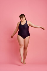 Obraz na płótnie Canvas Overweight woman poses in swimsuit, body positive