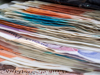 pile of British bank notes sterling cash