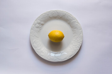 White plate with lemmon, isolated on white background