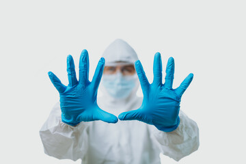 Fototapeta premium People wearing medical gloves and personal protective equipment, mask, goggle and suit to protect COVID-19 infection. hand signs or body language in the meaning of please stop; say no; or forbid; 