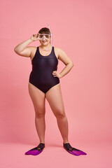 Overweight woman in swimsuit, fins and mask