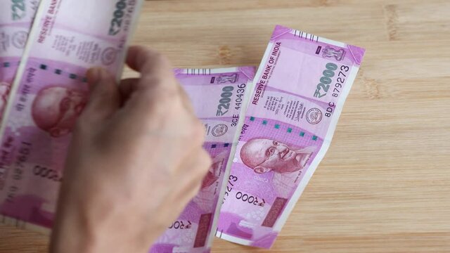 Counting Indian currency Rupee , hand giving Indian money 100, 200, 2000 rupees banknote Kerala India 4K slow motion video, footage. Business woman counting giving money cash new Indian currency notes