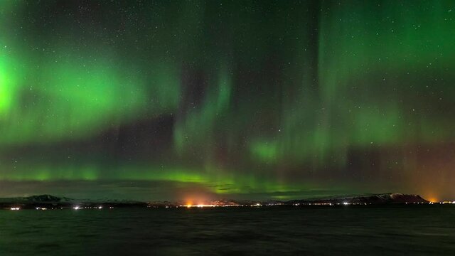 Active Northern lights on the sky over Hveragerdi town in Iceland - time-lapse video