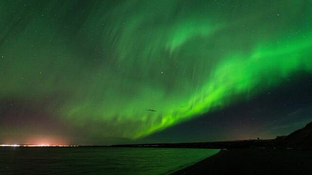 A ribbon of Northern lights across the sky in Iceland - time-lapse video