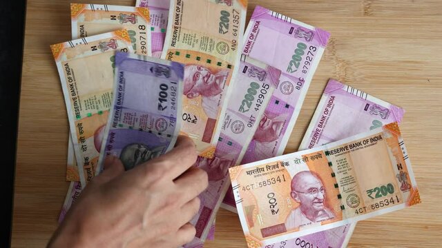 Counting Indian currency Rupee , hand giving Indian money 100, 200, 2000 rupees banknote Kerala India 4K slow motion video, footage. Business woman counting giving money cash new Indian currency notes