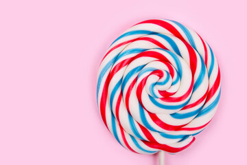 Colorful lollipop on pastel pink background