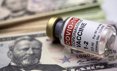 Covid-19 vaccine next to several dollar notes, conceptual image