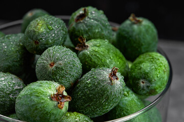 Feijoa whole on black background. Exotic fruit. Selective focus. Closeup.