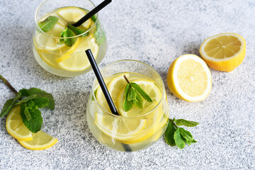 Fresh summer drink. Cold lemonade with mint on a concrete background.