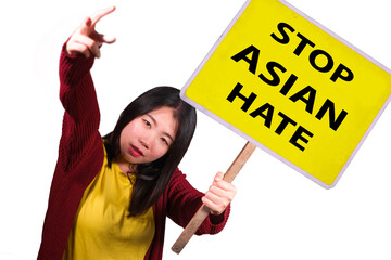 young pretty and upset Korean woman holding stop Asian hate billboard in human rights defense...
