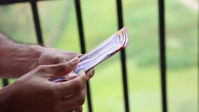 Counting Indian currency Rupee , hand giving Indian money 100, 200, 2000 rupees banknote Kerala India 4K slow motion video, footage. Business woman counting giving money cash new Indian currency notes