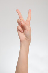 Peace hand gesture isolated on white background.