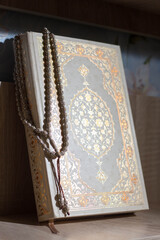 The Holy Quran with tasbih or rosary beads. Islamic concept. Ramadan.