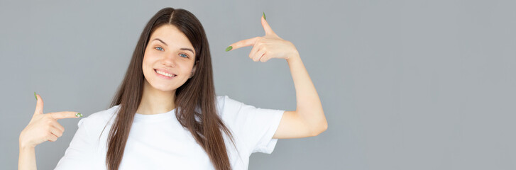 Young beautiful woman over isolated background looking confident with smile on face, pointing oneself with fingers proud and happy.