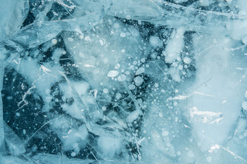 Texture of pure blue cracked ice of lake Baikal. Drawings of nature