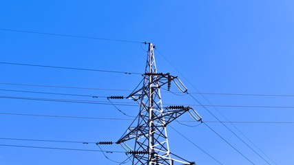 metal tower for high voltage transmission line on blue sky background