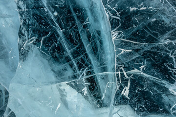 Texture of pure blue cracked ice of lake Baikal. Drawings of nature