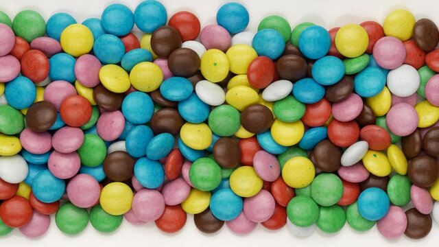 Colored chocolate dragees. Sweets, dolly shot.