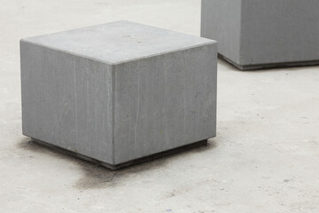 Urban architecture concept. Gray cubes with cement on concrete background. Copy-space. Outdoor shot