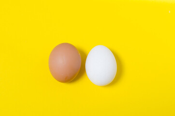 brown and white eggs on yellow background