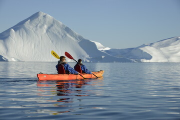 Kayak near icebergs in Ilulissat, Disko Bay, Greenland