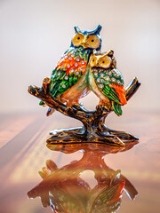 Figure of two owls sitting on a branch