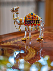 Souvenir camel figurine on a reflective surface