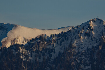 Snow-covered mountain ridge in the winter evening light