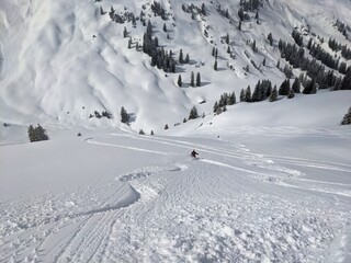 skier draws his own track through the powder snow. Freeride in the mountains of glarus on the silbern. mountaineering