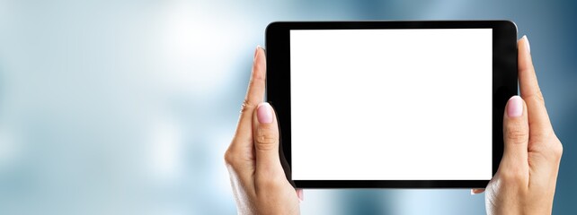 Human hands holding digital tablet with a white blank screen