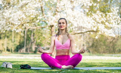 Woman doing yoga in spring park