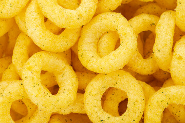 Beer snacks. Background of corn rings of sticks with cheese and green onion flavor.