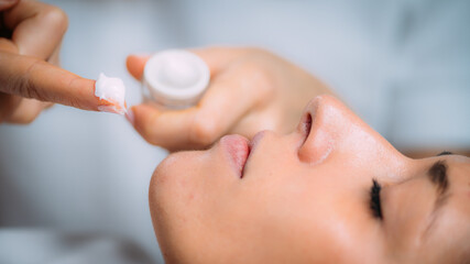 Cosmetician Applying Cream on Woman’s Face