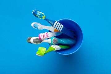 Toothbrushes on a blue background. Concept toothbrush selection. Oral cavity care. Dental hygiene.