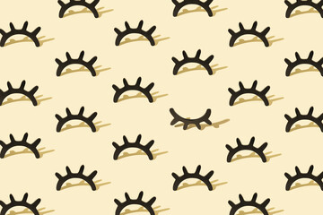 Creative pattern with wooden eyelashes on a pastel yellow background. Minimalist concept. Isometric layout.